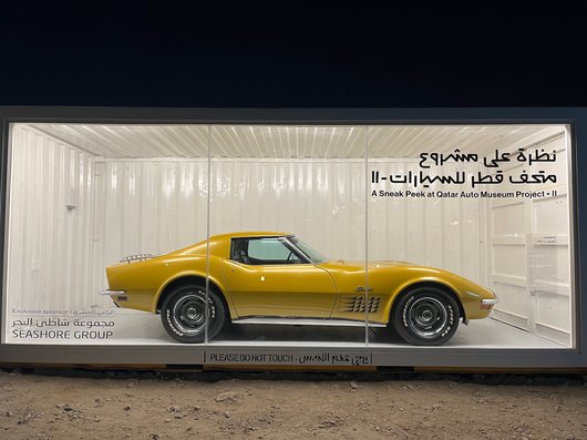 Yellow Chevrolet Corvette car in a display case