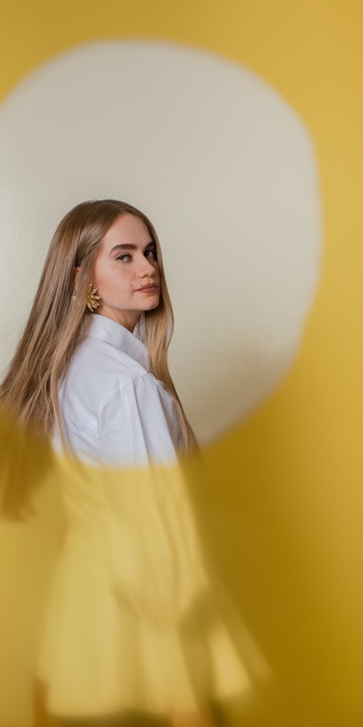 woman with long hair wearing a suit
