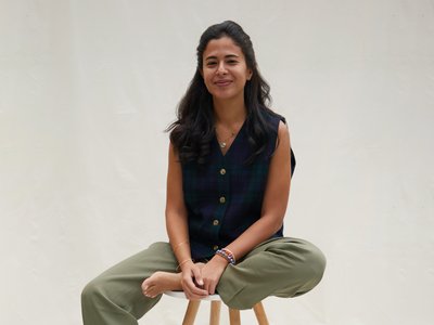 Woman sitting on a stool