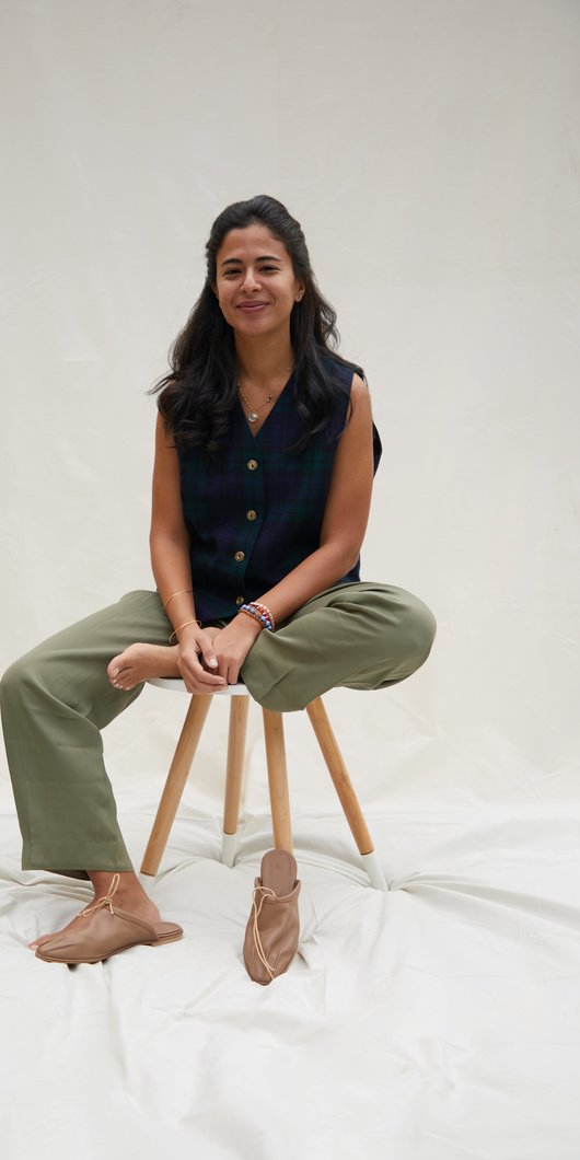 Woman sitting on a stool