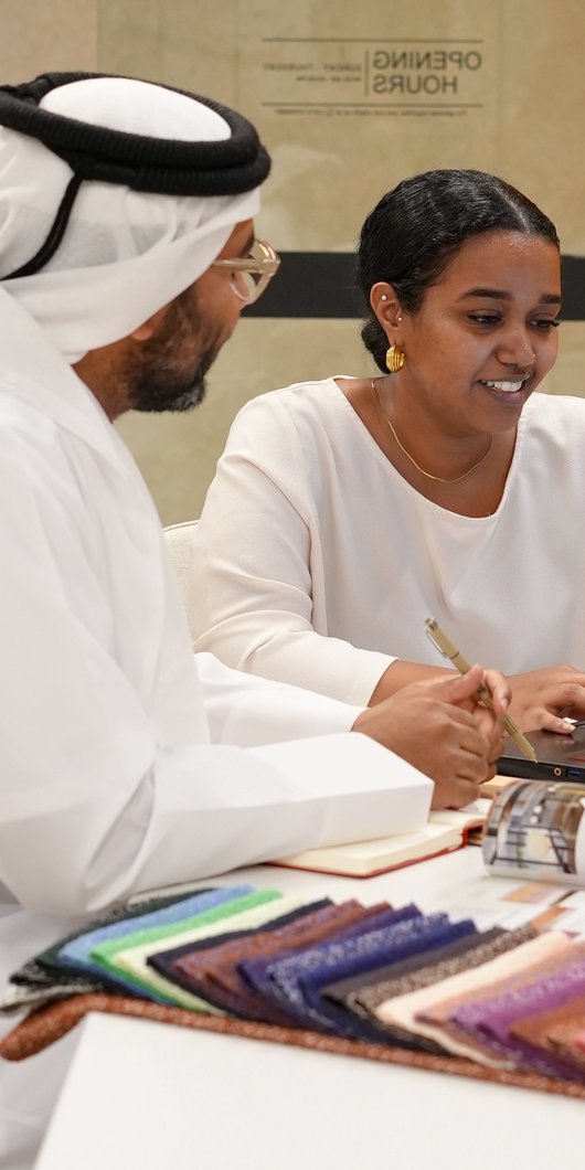 Two people talking and working