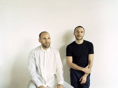 two designers posing