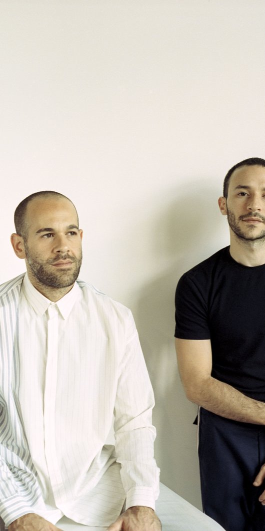 two designers posing