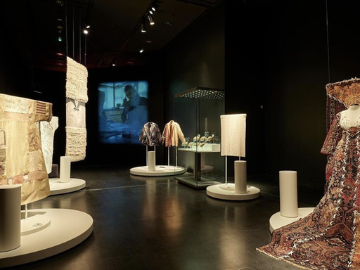 Exhibition with tapestry and dresses