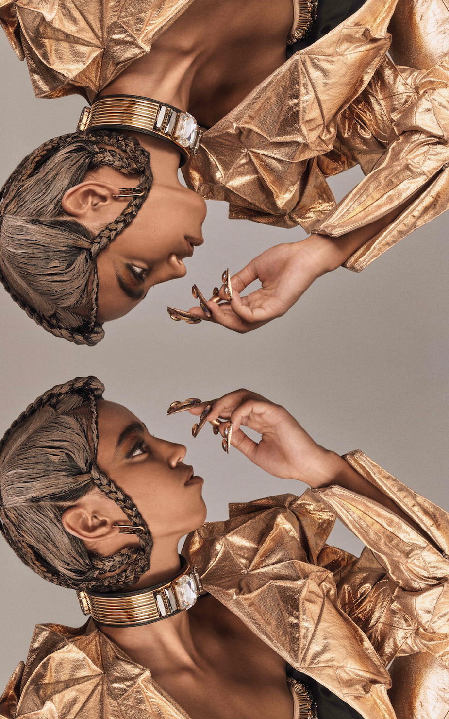 Mirror of a model wearing gold jacket and couture braids