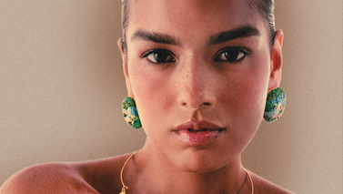 Woman showing pieces of clothing on a rack