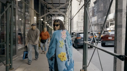 Women walking in the street wearing a blue coat
