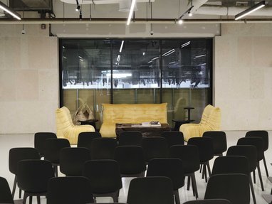 Speaking area room with couch area and chairs