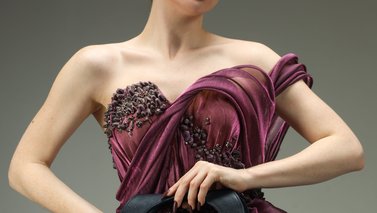 Model posing with dark makeup and handbag