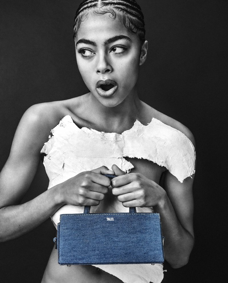 Model holding handbag