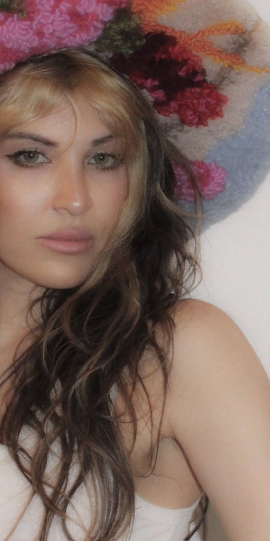 woman posing in front of colorful backdrop