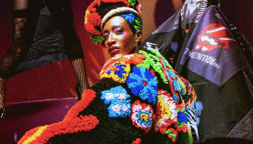 Model posing in a dark but colorful scene