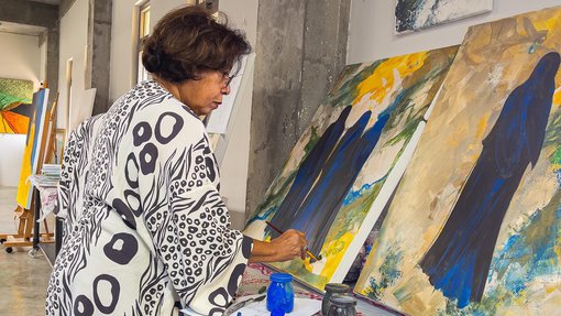 Ruwad Artist Wafika Sultan Al-Essa working in the corner of her studio at the Fire Station.