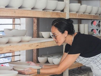 artist holding pottery