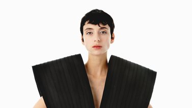 Woman wearing a black sculptural dress