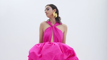 Model in hot pink long dress