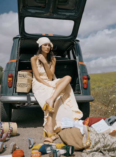 women sitting in the back of a trunk