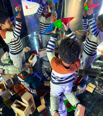 Children playing with magnetic building blocks to create interesting shapes