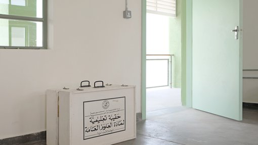 Interior view of an empty room with an open green door.
