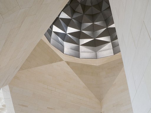 View showing interior of the Museum of Islamic Art with angular marble walls and decorative ceiling dome