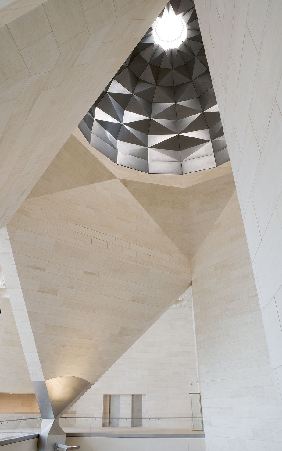View showing interior of the Museum of Islamic Art with angular marble walls and decorative ceiling dome
