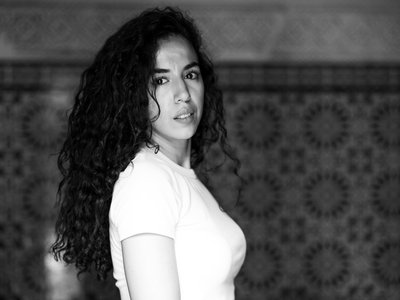 Black and white image of woman with curly hair