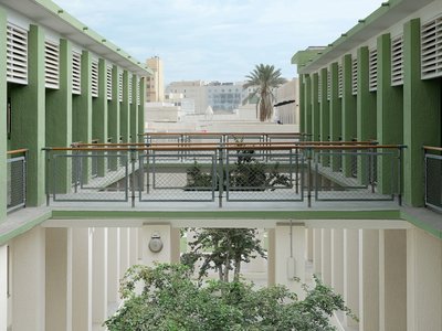 Elevated view looking across Liwan's courtyard with a tree and cross-walk.