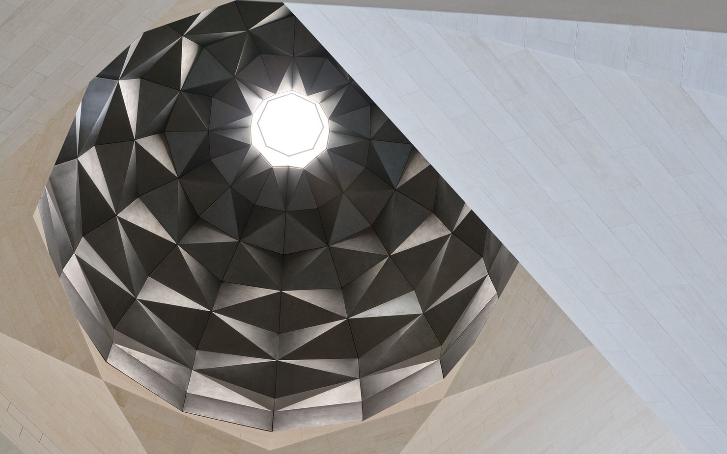 A view of MIA's dome-like ceiling with intricate architectural designs