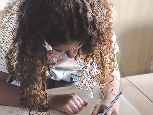 Close-up of a little girl writing on a paper