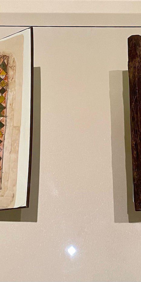 Two manuscripts behind a display case at the National Museum of Qatar