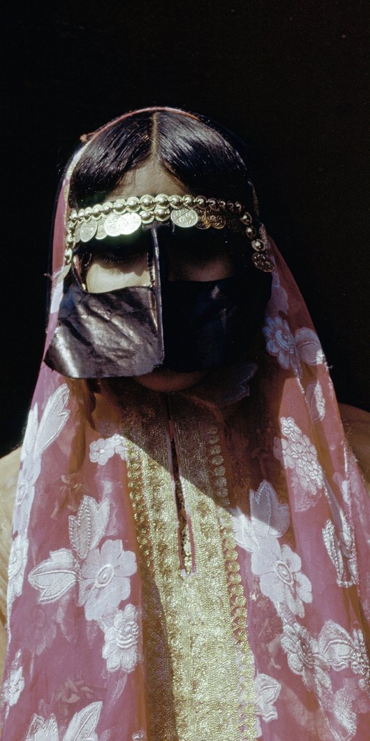 Woman wearing traditional Qatari dress and face covering