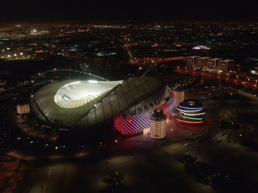 A night time image of QOSM flanked by Khalifa International Stadium