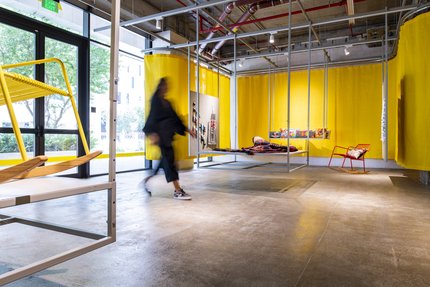 A women entering Studio 7 concept store surrounded by product displays.