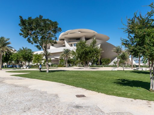 A view of The Park with trees, grass, walkways and the NMoQ building in the background